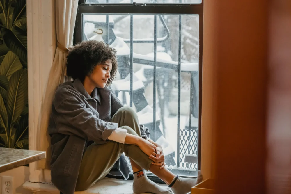 woman looking out window